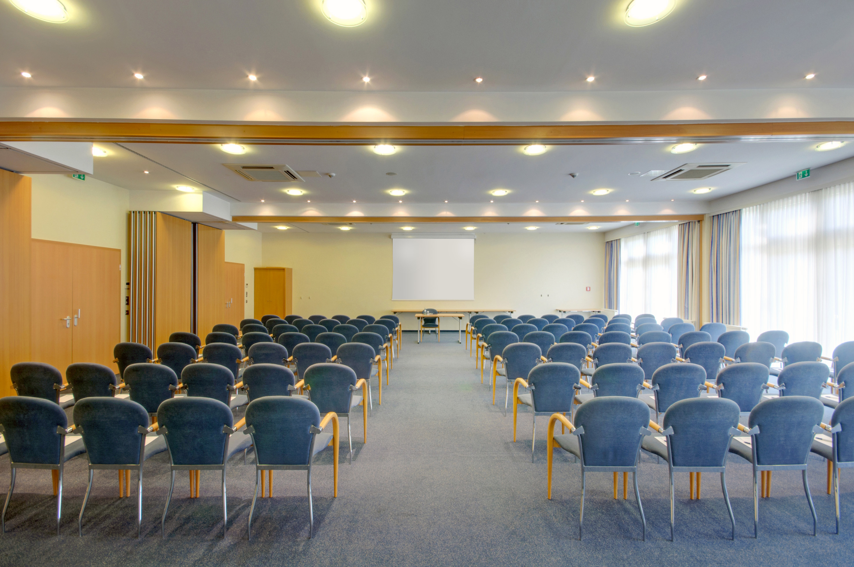 a room with chairs and a projector screen