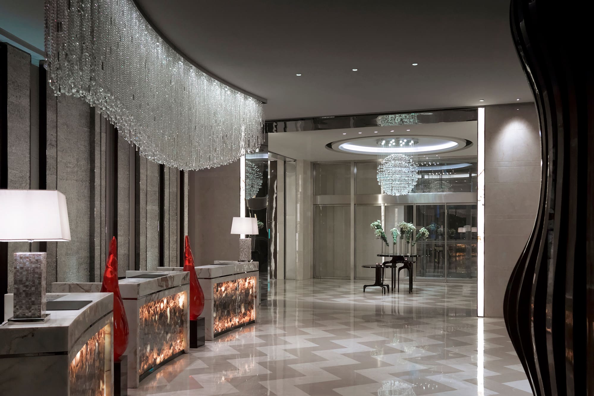 a lobby with chandeliers and a piano