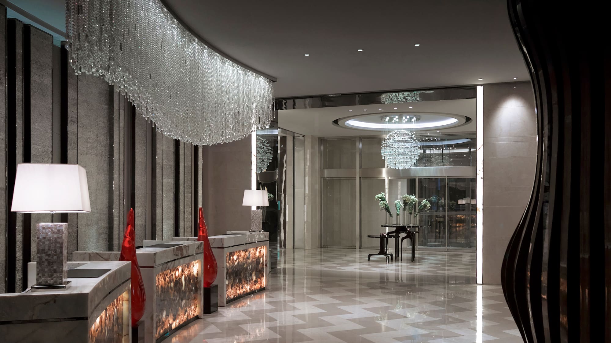 a lobby with chandeliers and a piano