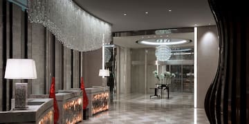 a lobby with chandeliers and a piano