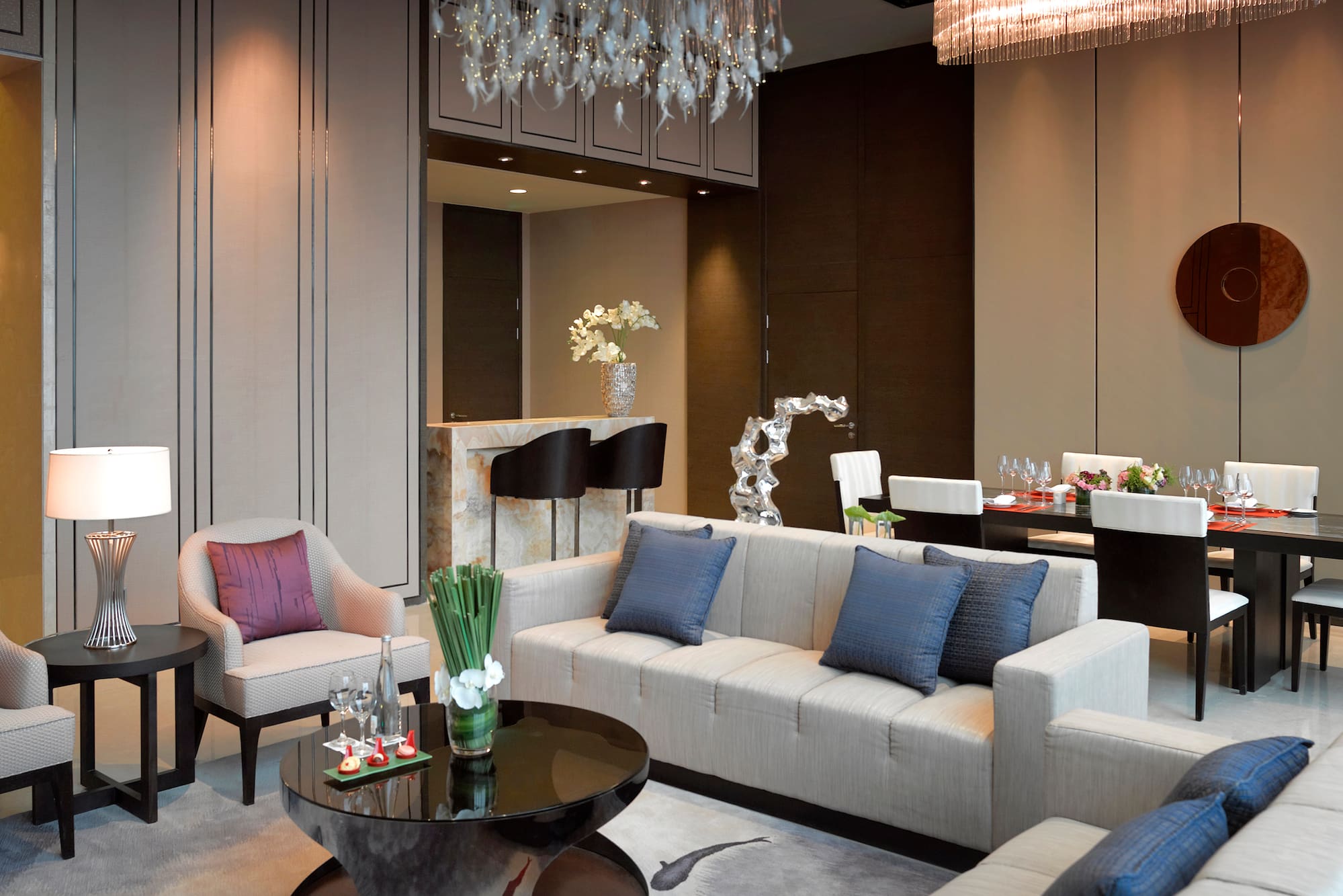 a living room with a chandelier and couches