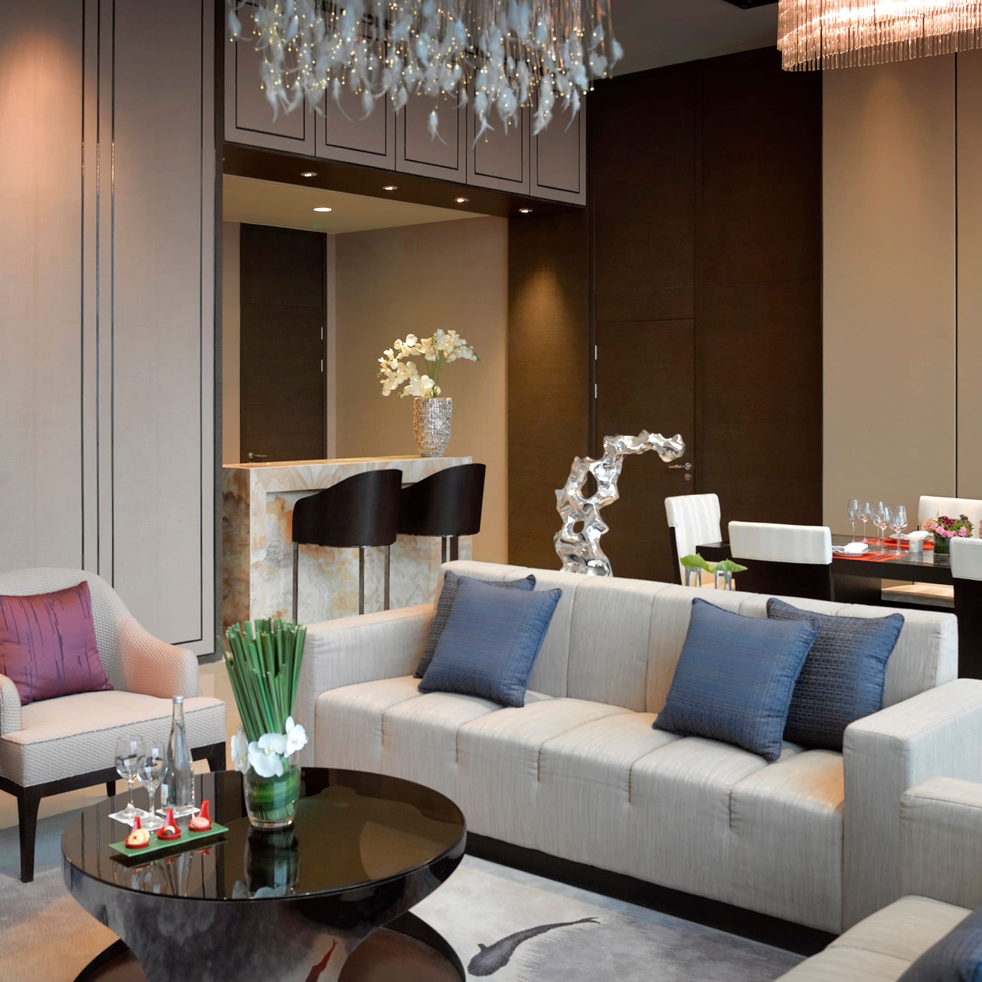 a living room with a chandelier and couches