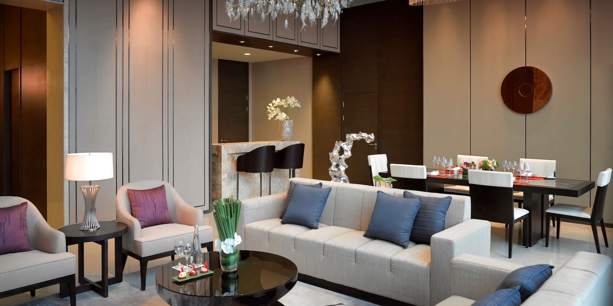 a living room with a chandelier and couches