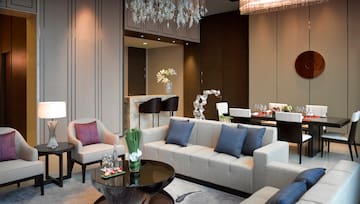 a living room with a chandelier and couches