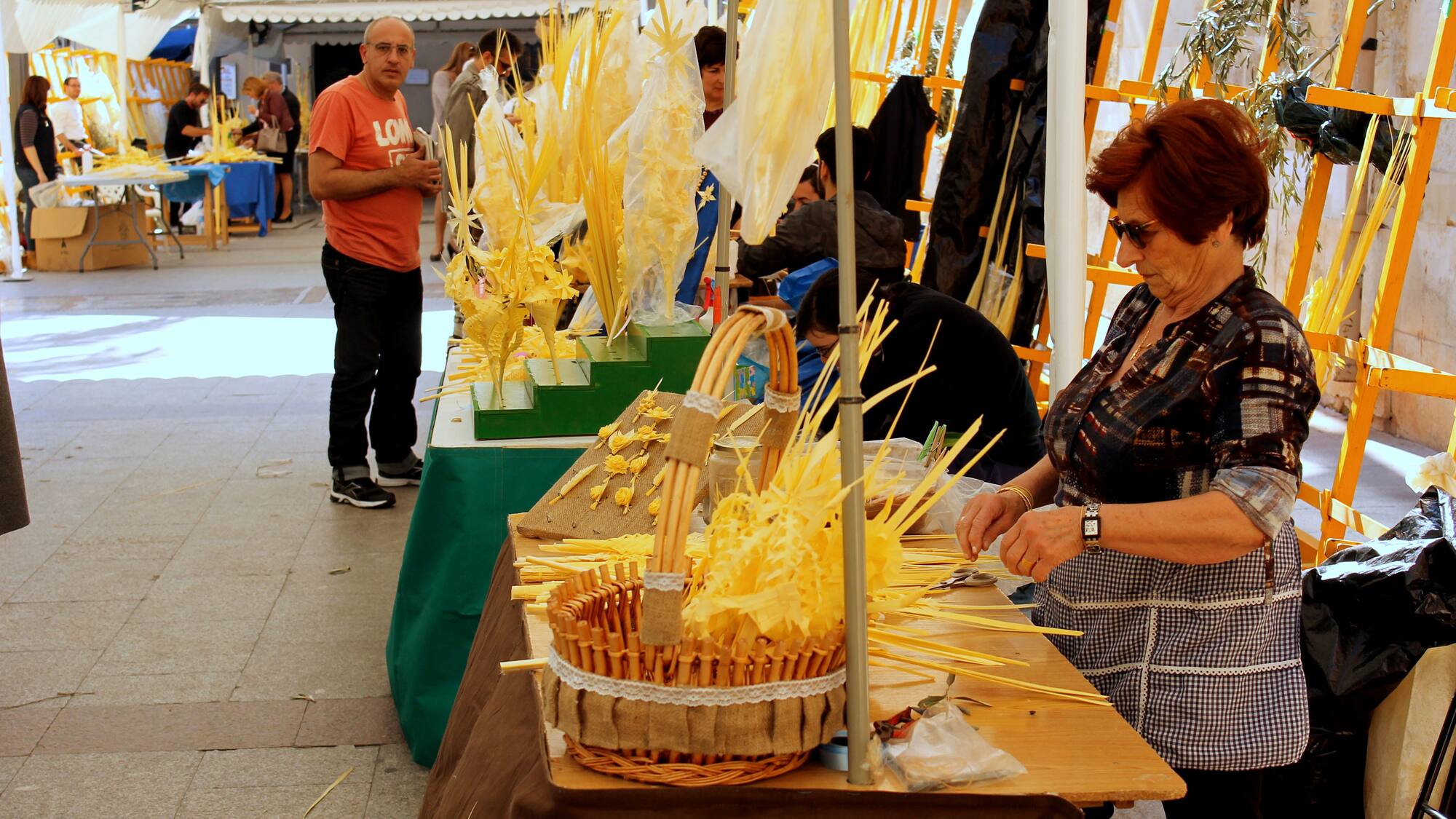 a woman cutting a basket of straw