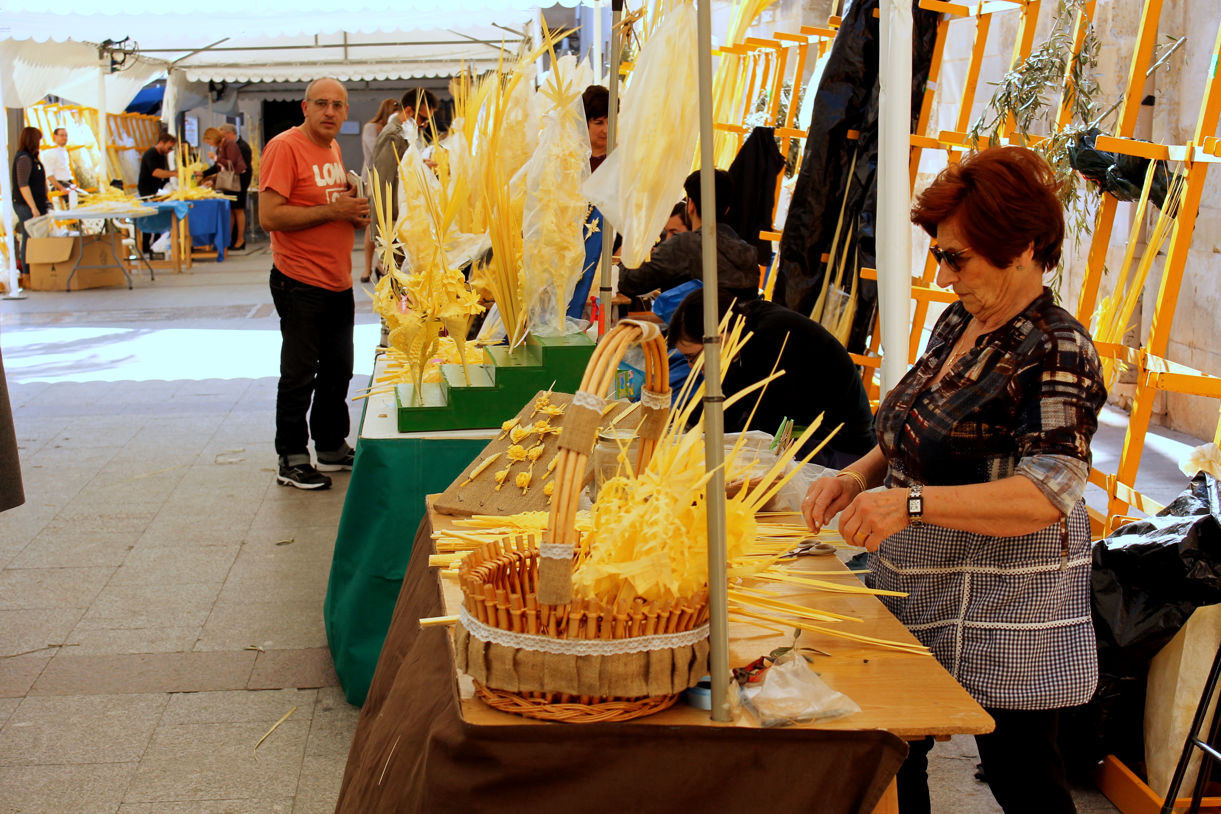 a woman cutting a basket of straw