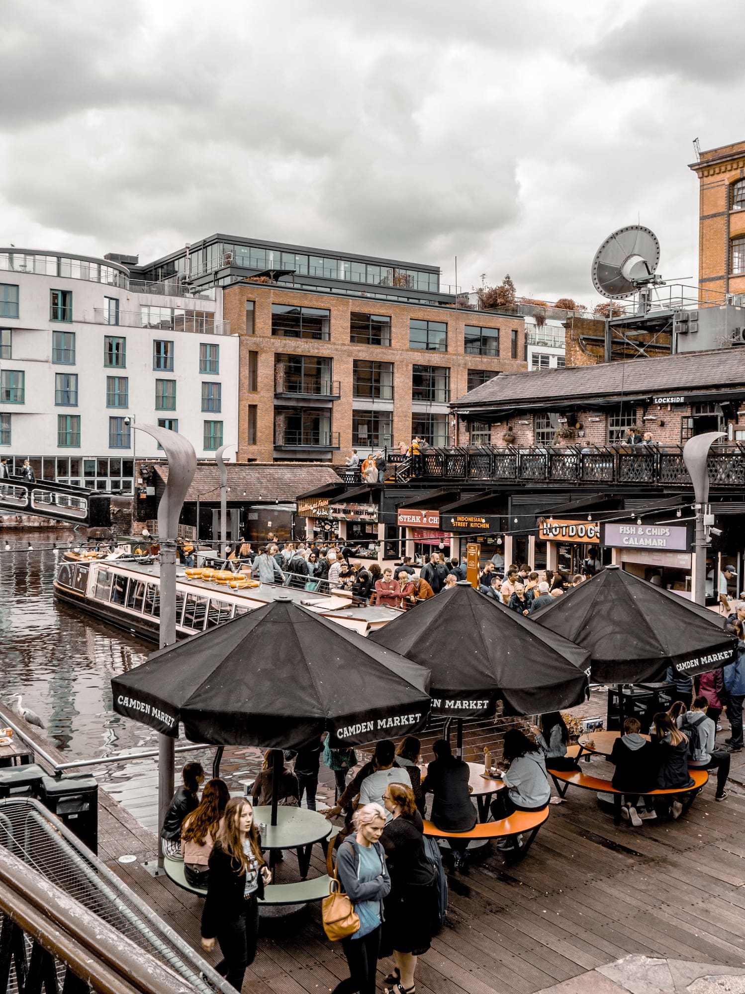 a group of people outside with umbrellas