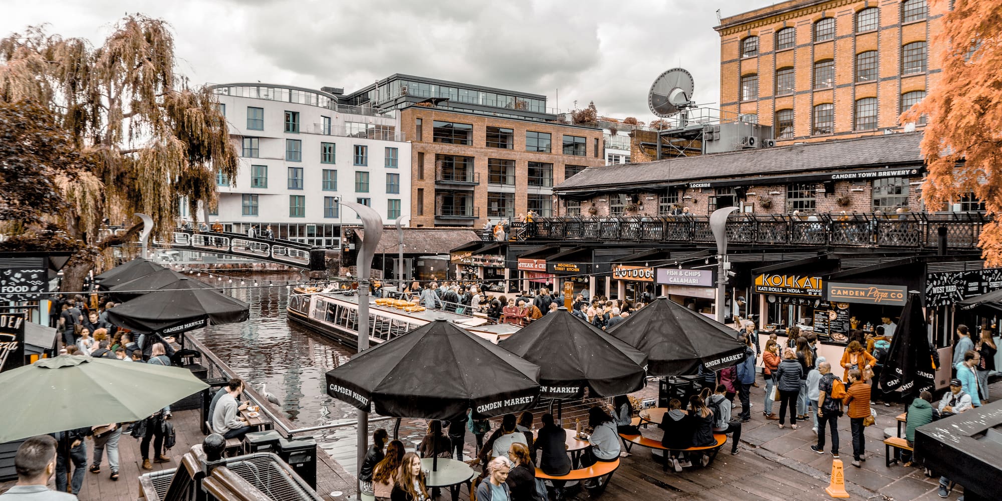 a group of people outside with umbrellas