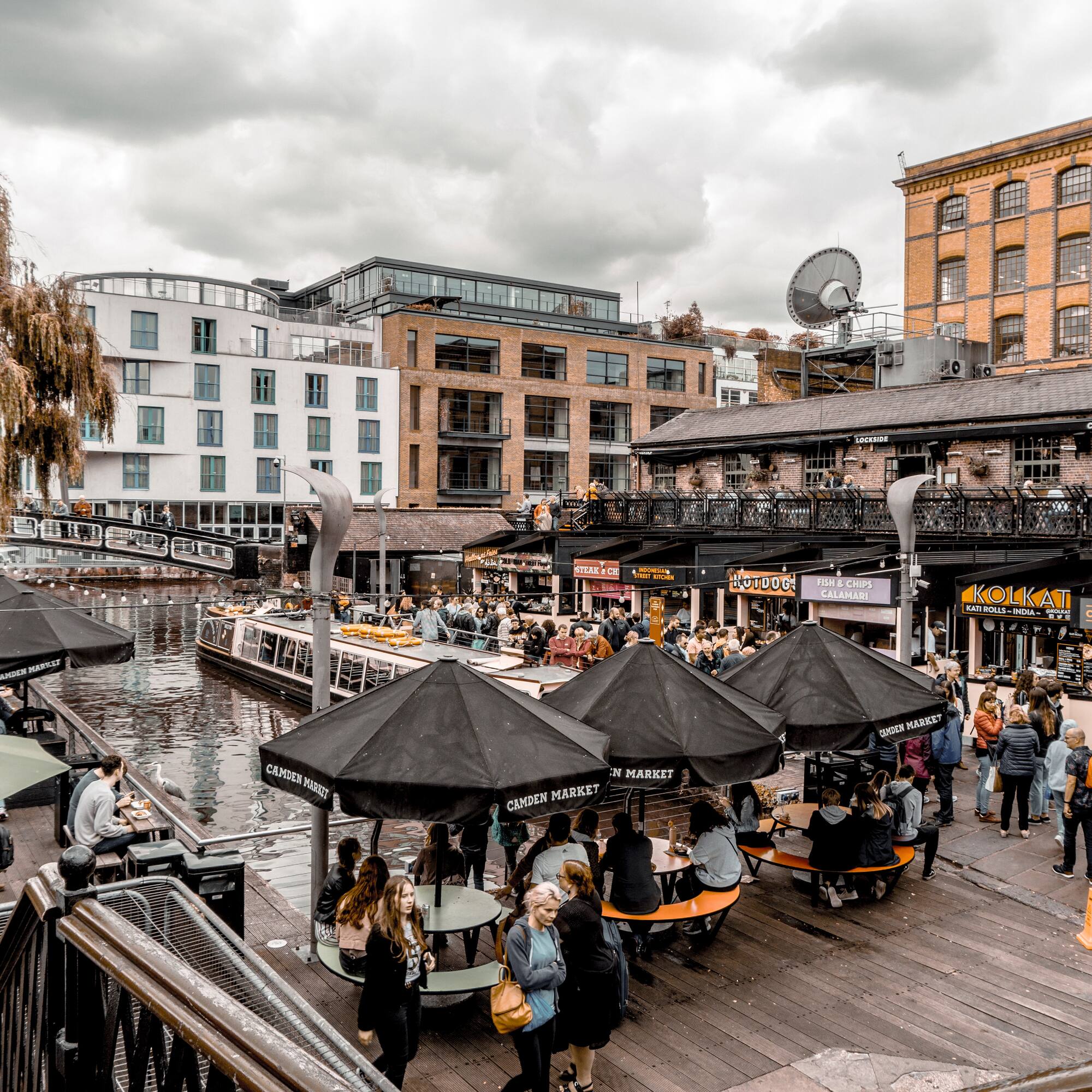 a group of people outside with umbrellas