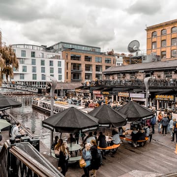 a group of people outside with umbrellas