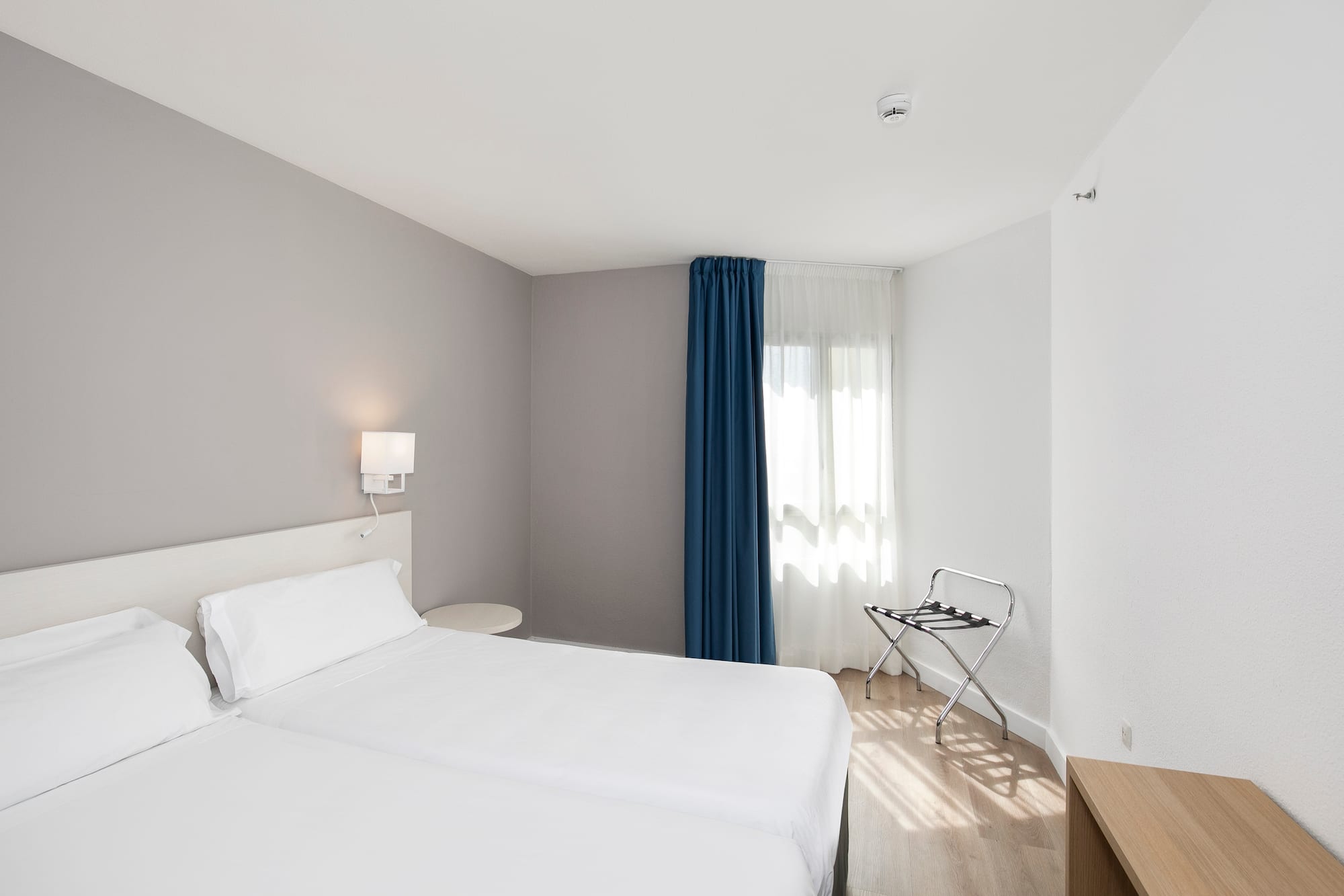 a room with two beds and a lamp