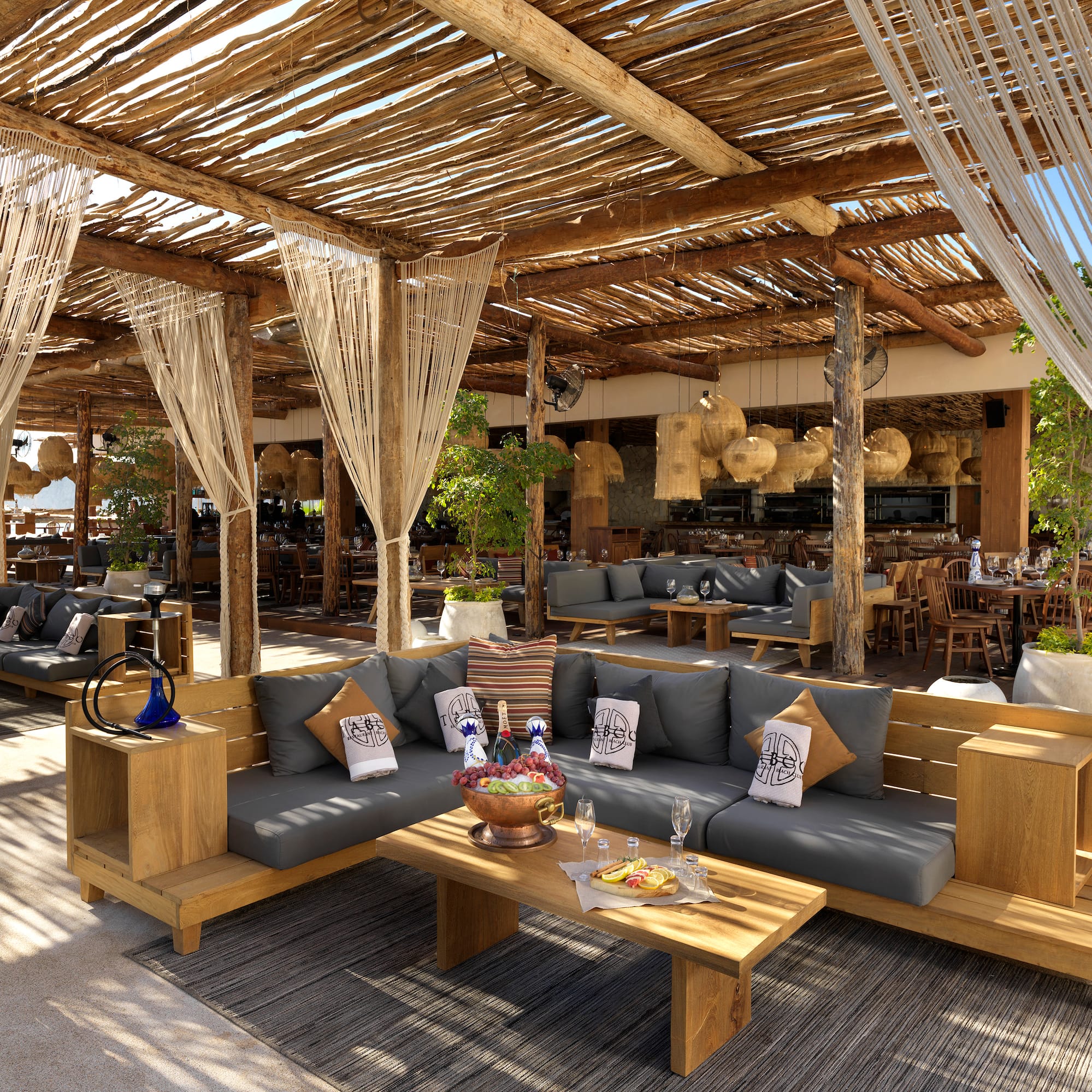 a patio with a large area with a couch and tables