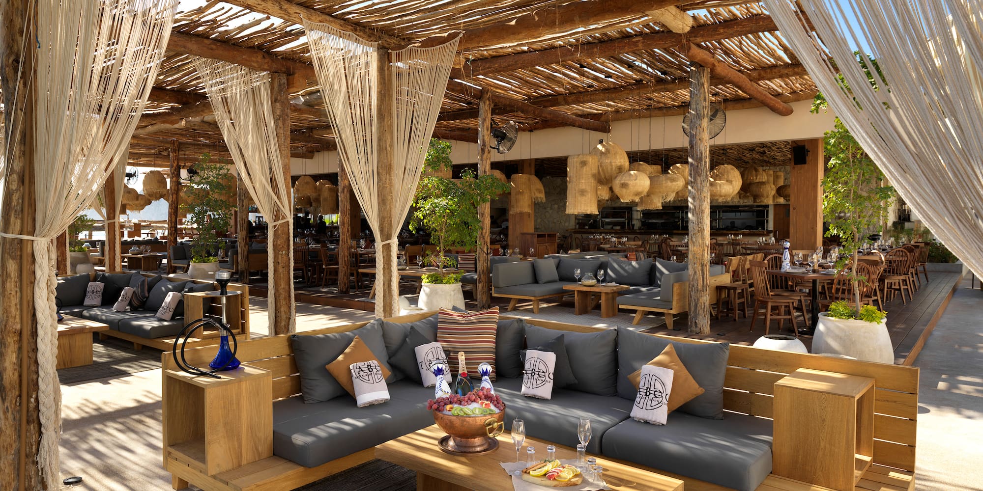 a patio with a large area with a couch and tables