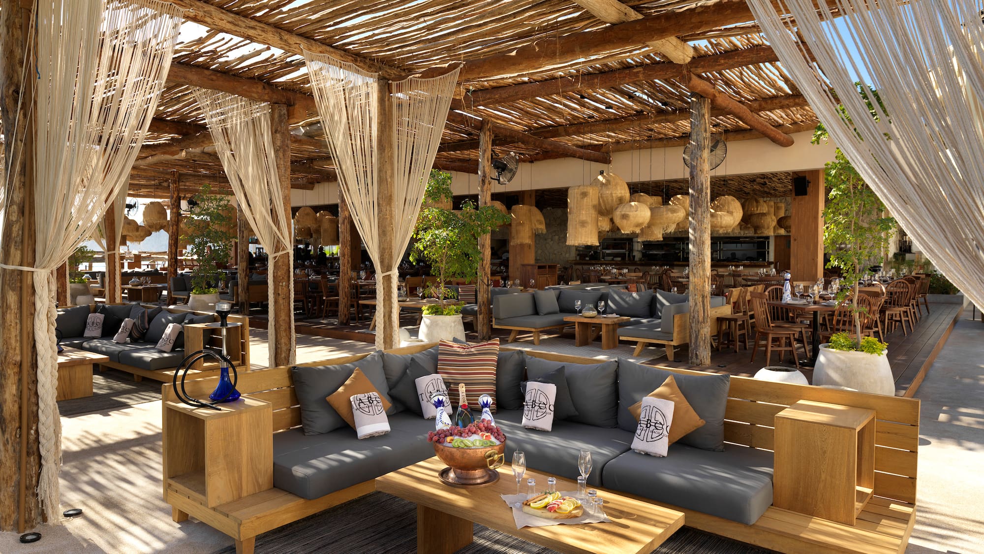 a patio with a large area with a couch and tables