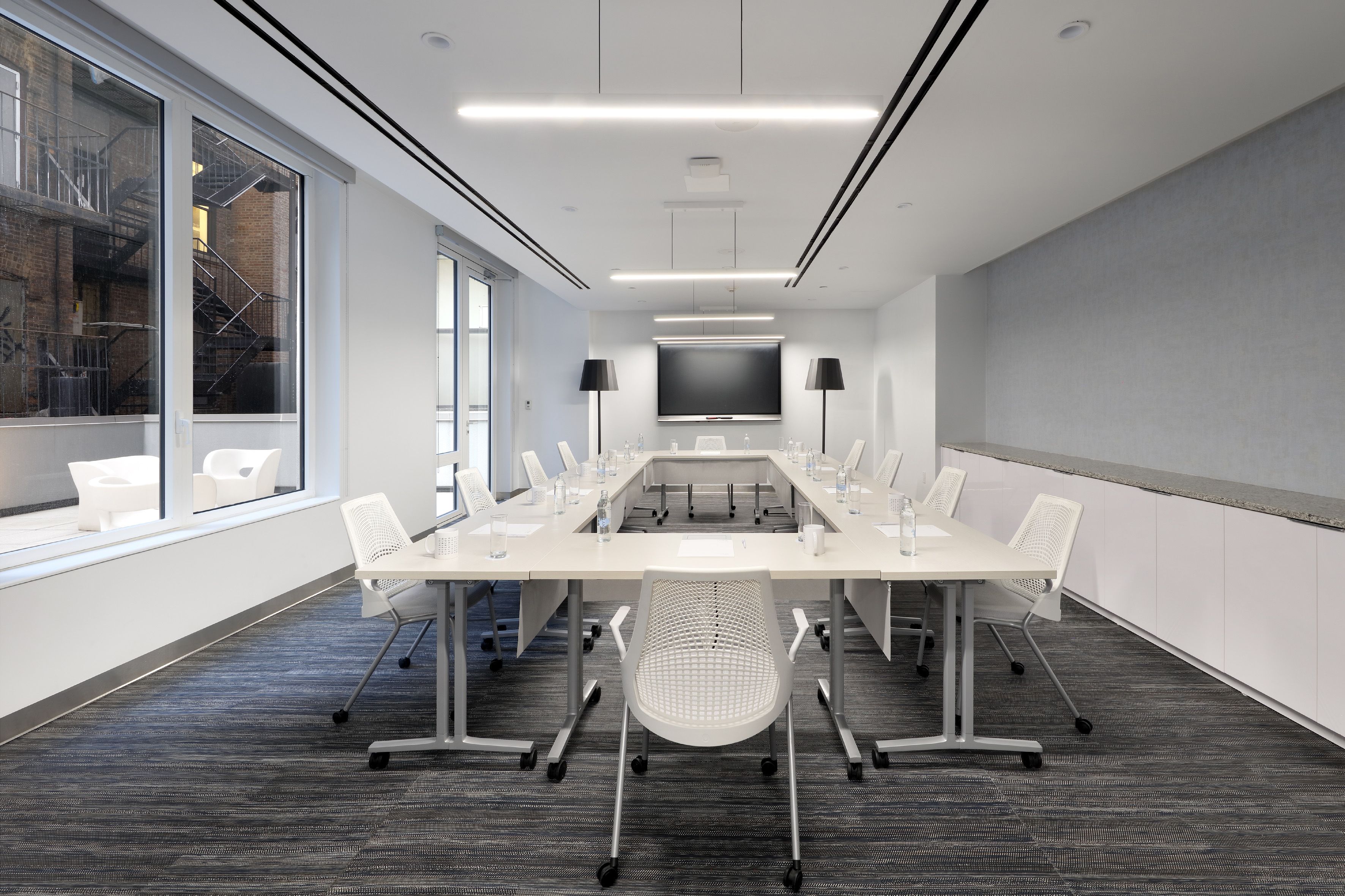 a room with a long table and chairs