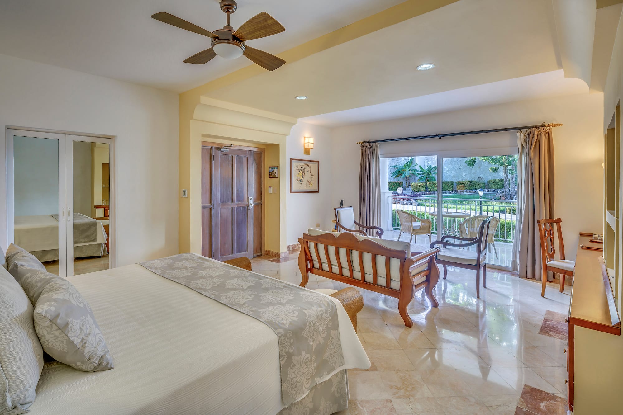 a bedroom with a bed and a wood chair