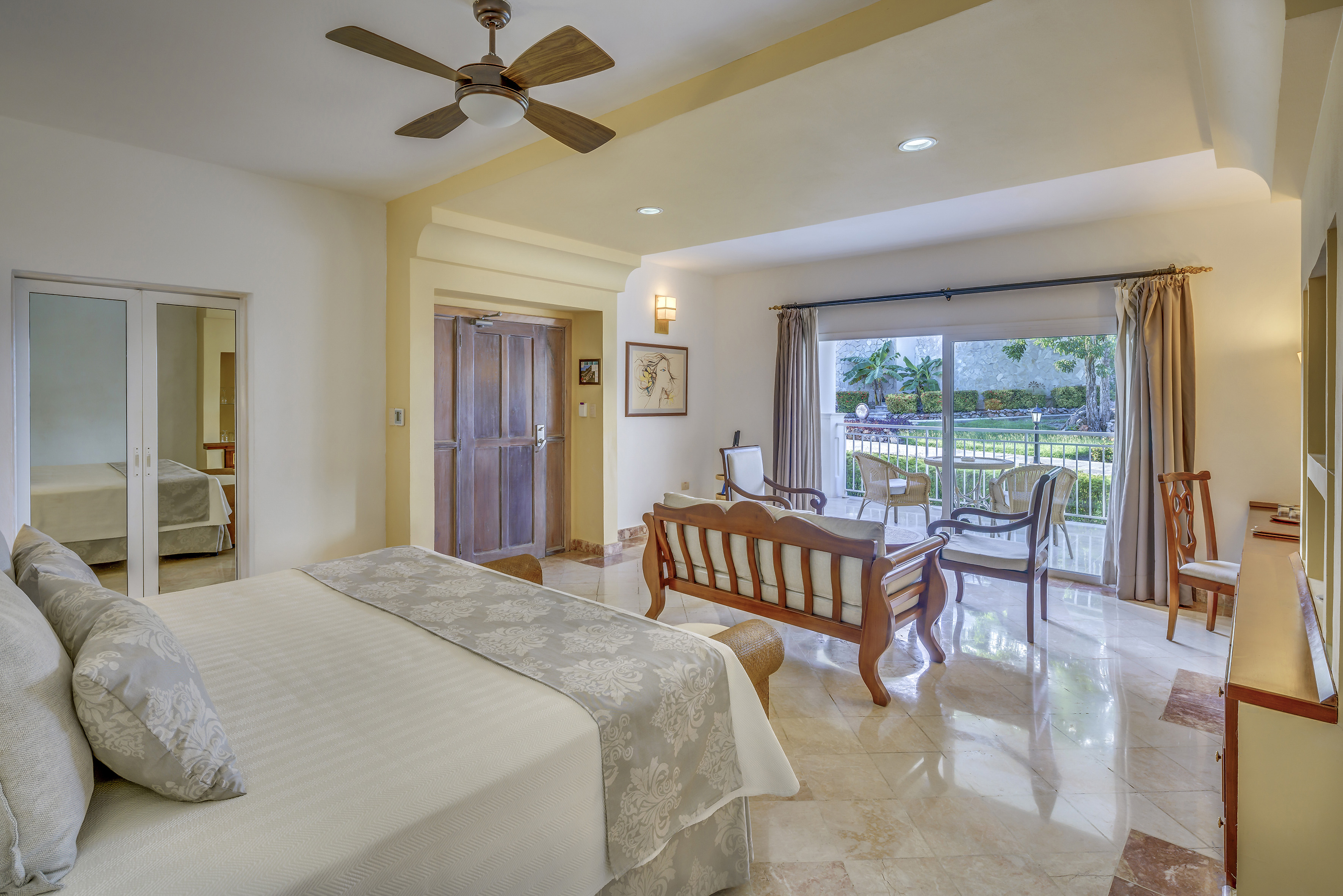 a bedroom with a bed and a wood chair