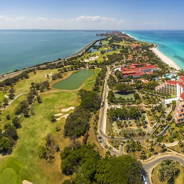 a aerial view of a golf course and a beach
