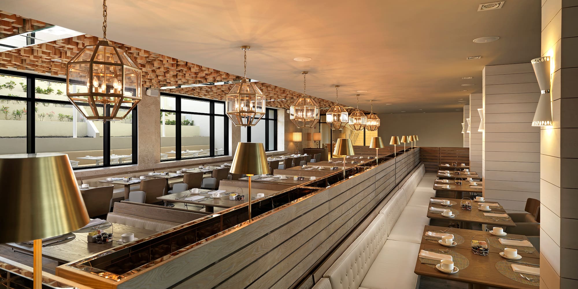 a long row of tables with chairs and lamps