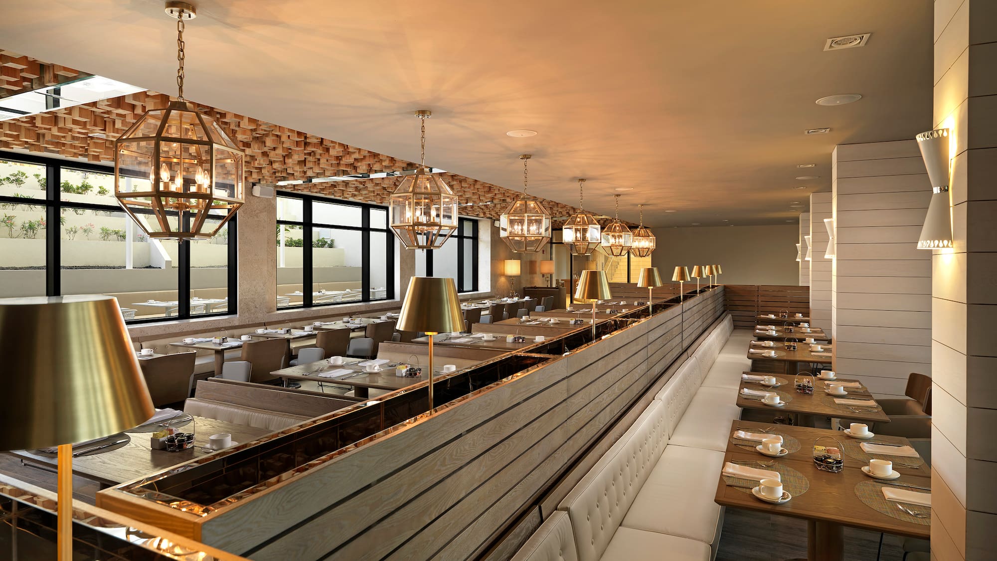 a long row of tables with chairs and lamps