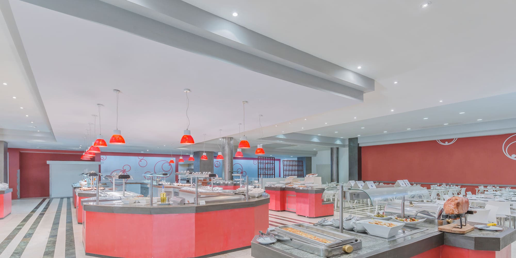 a large room with red counter tops