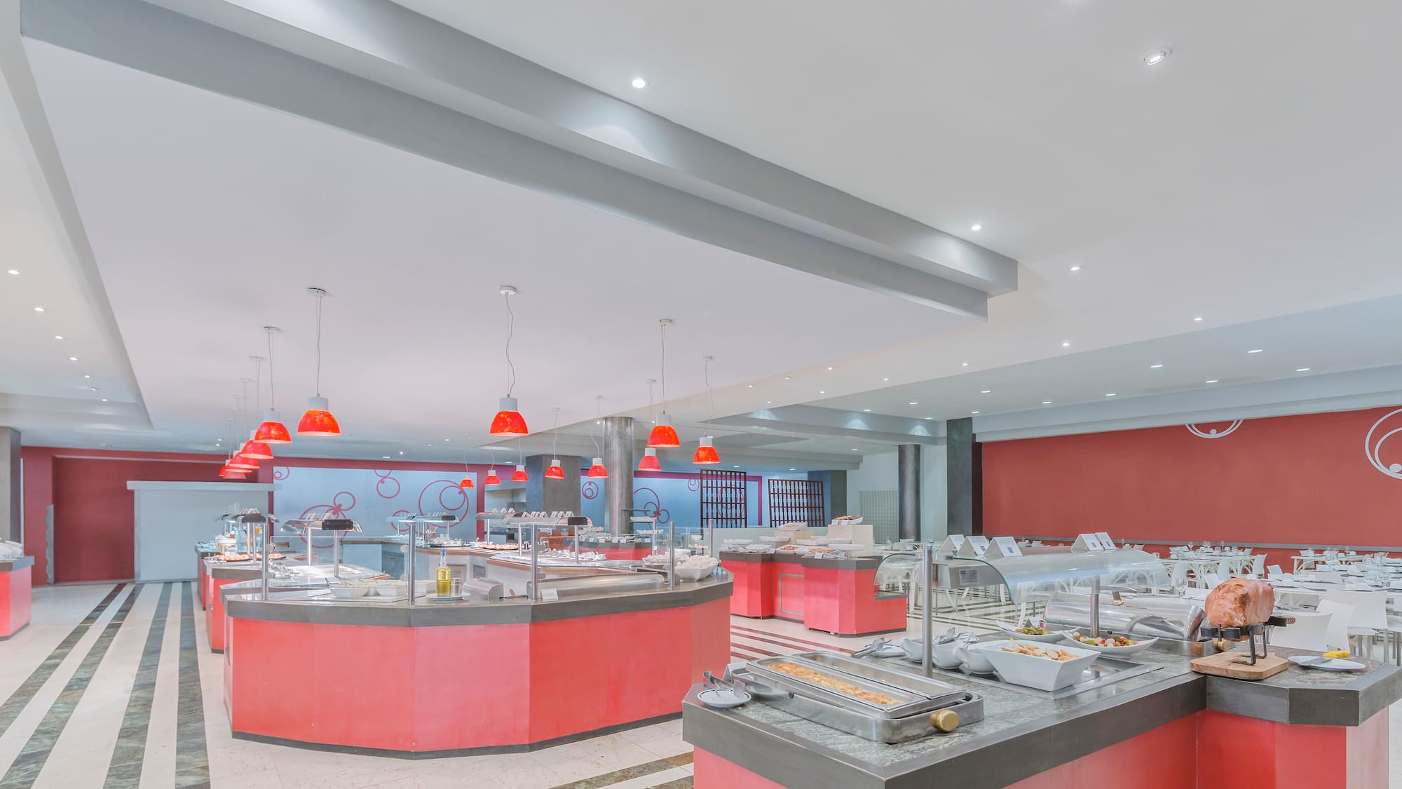 a large room with red counter tops