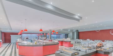 a large room with red counter tops