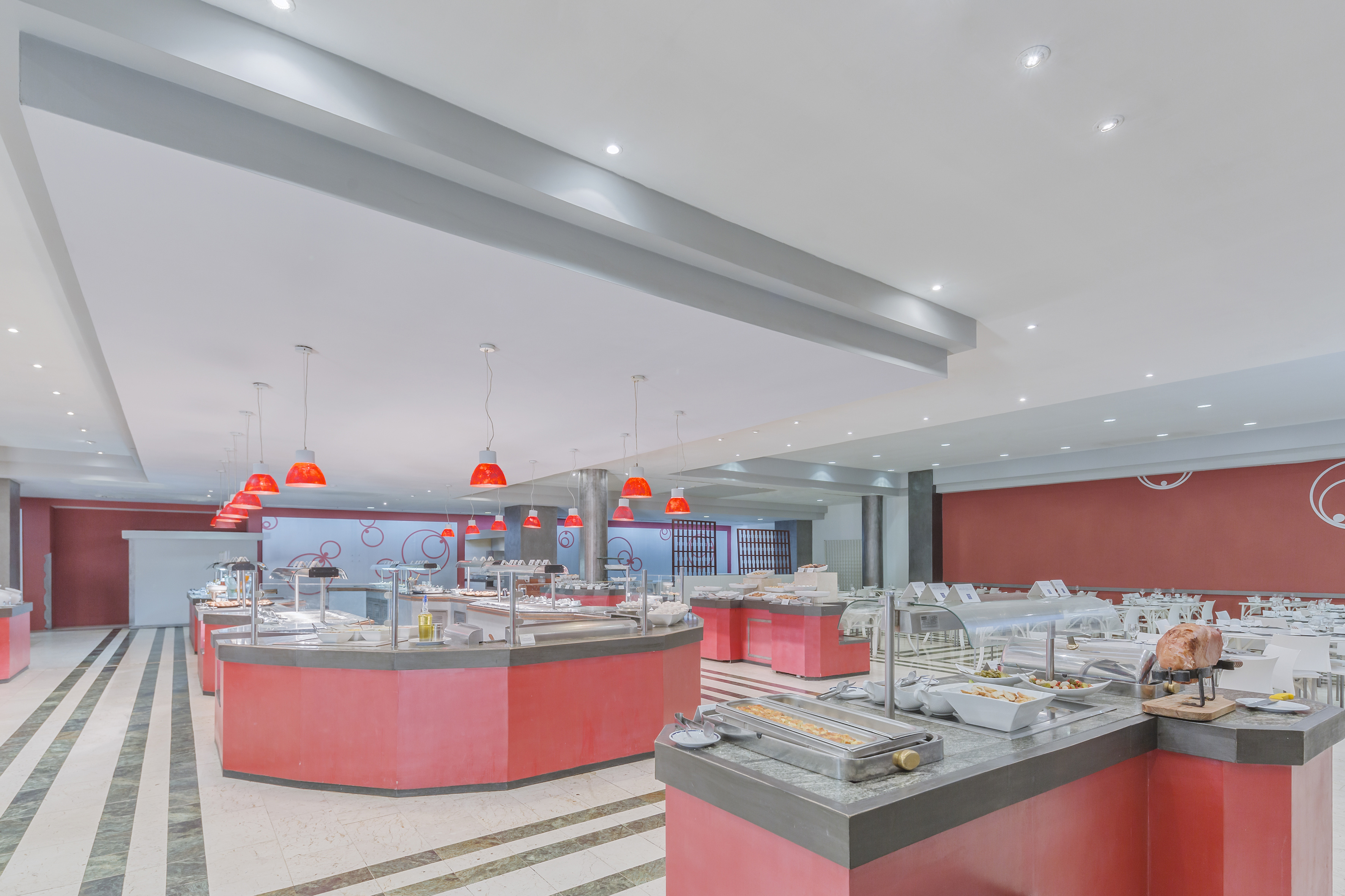 a large room with red counter tops