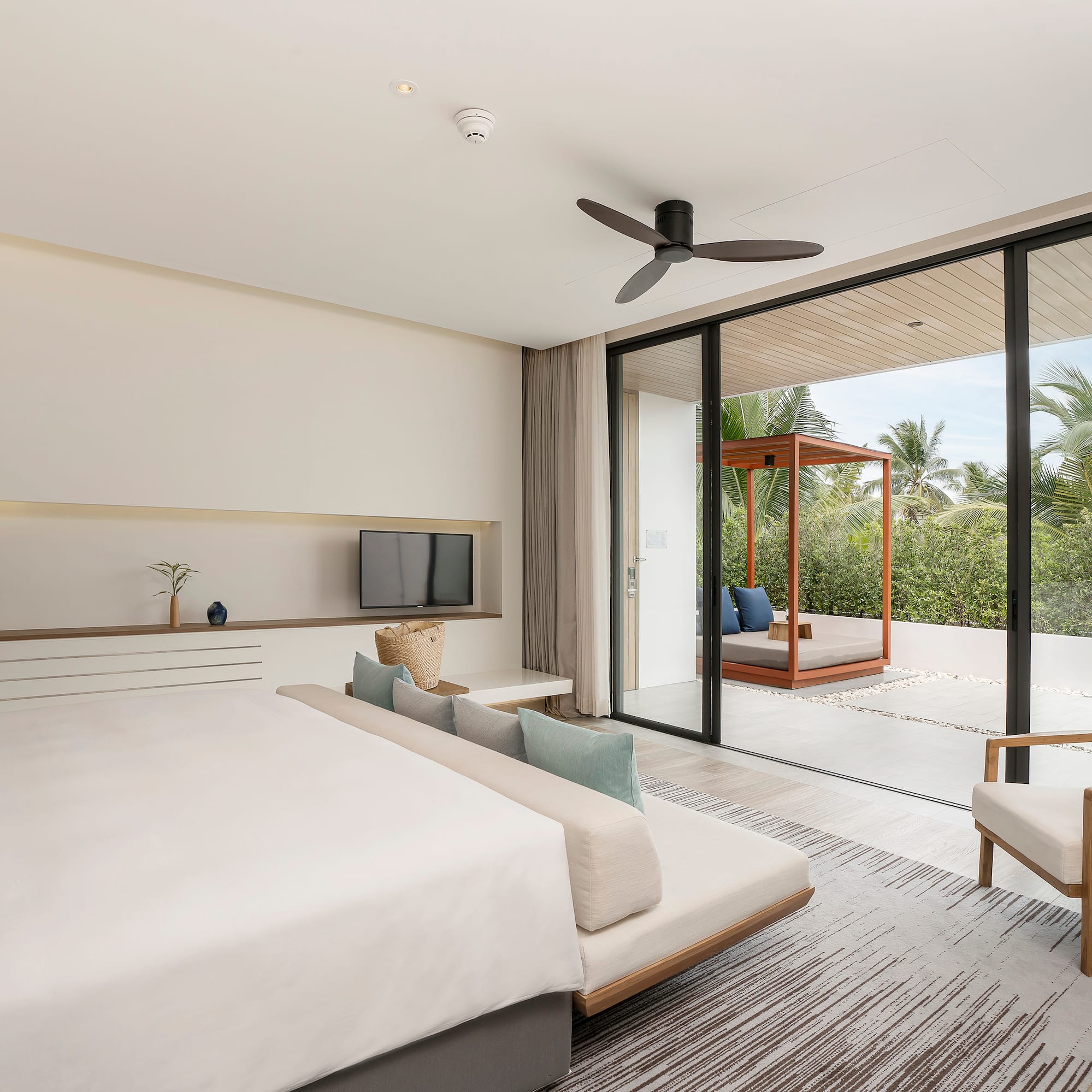 a bedroom with a large bed and a television