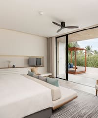 a bedroom with a large bed and a television