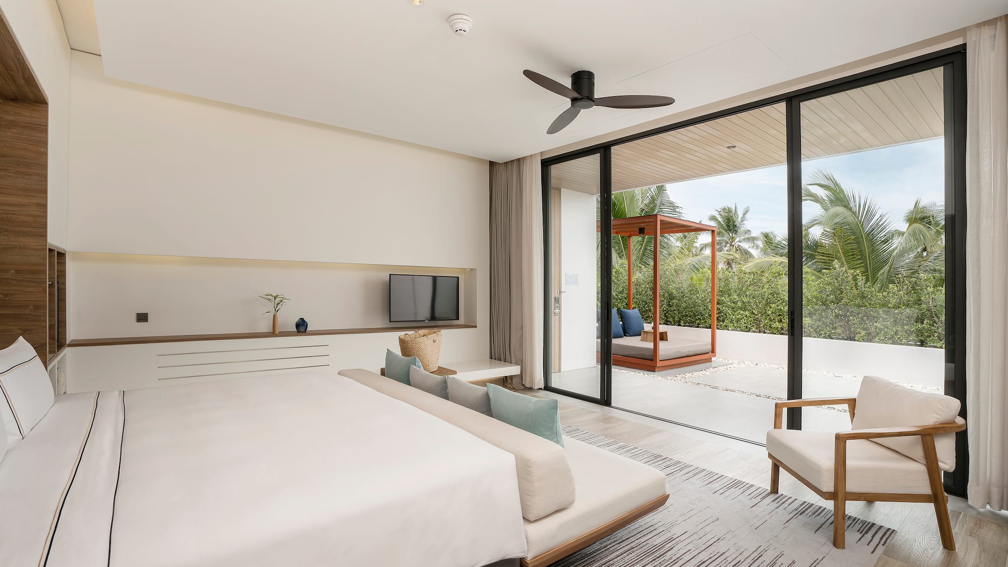 a bedroom with a large bed and a television