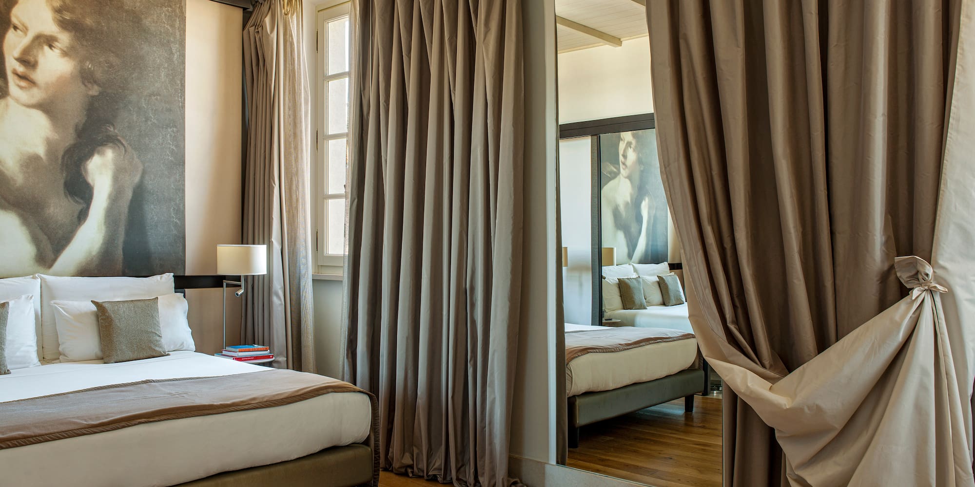 a room with a mirror and a bed