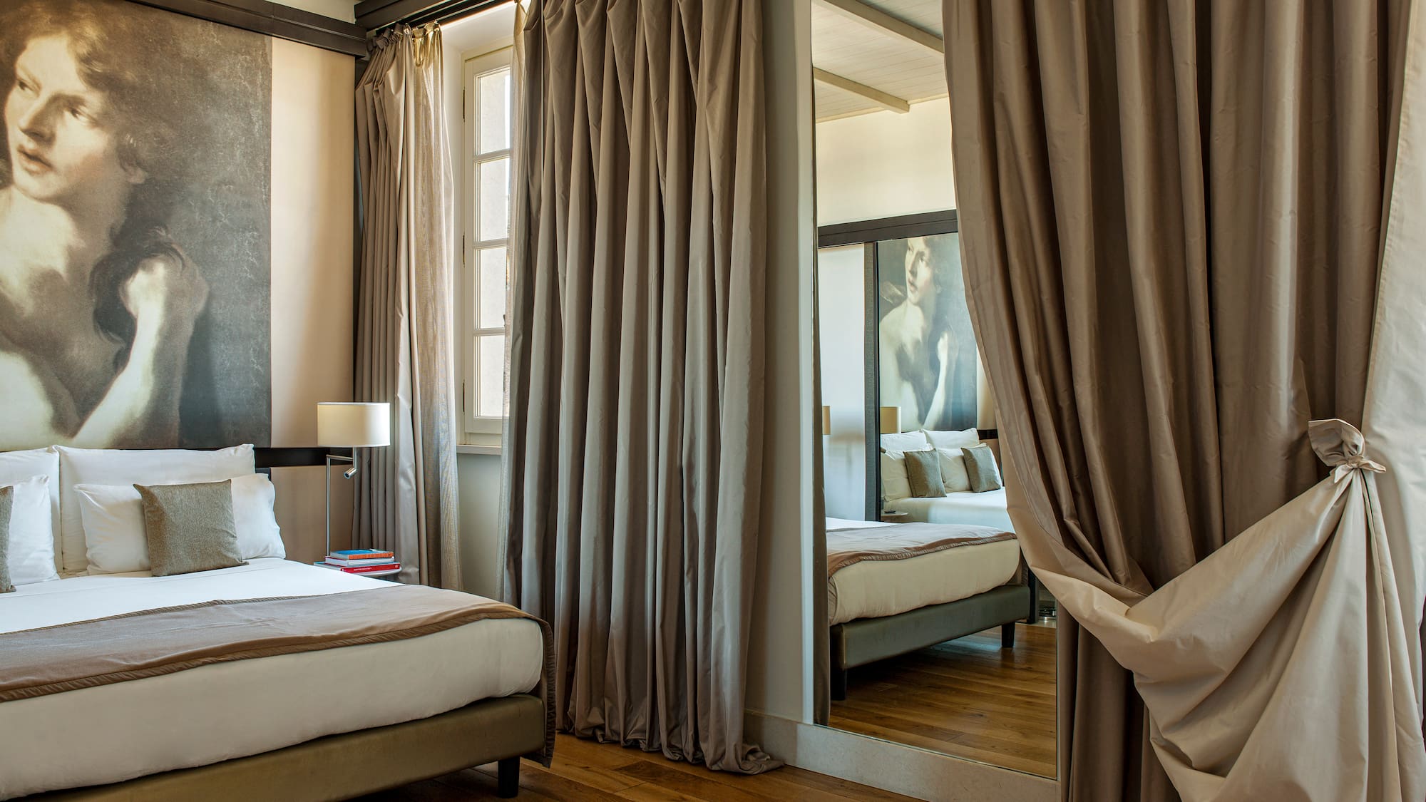 a room with a mirror and a bed