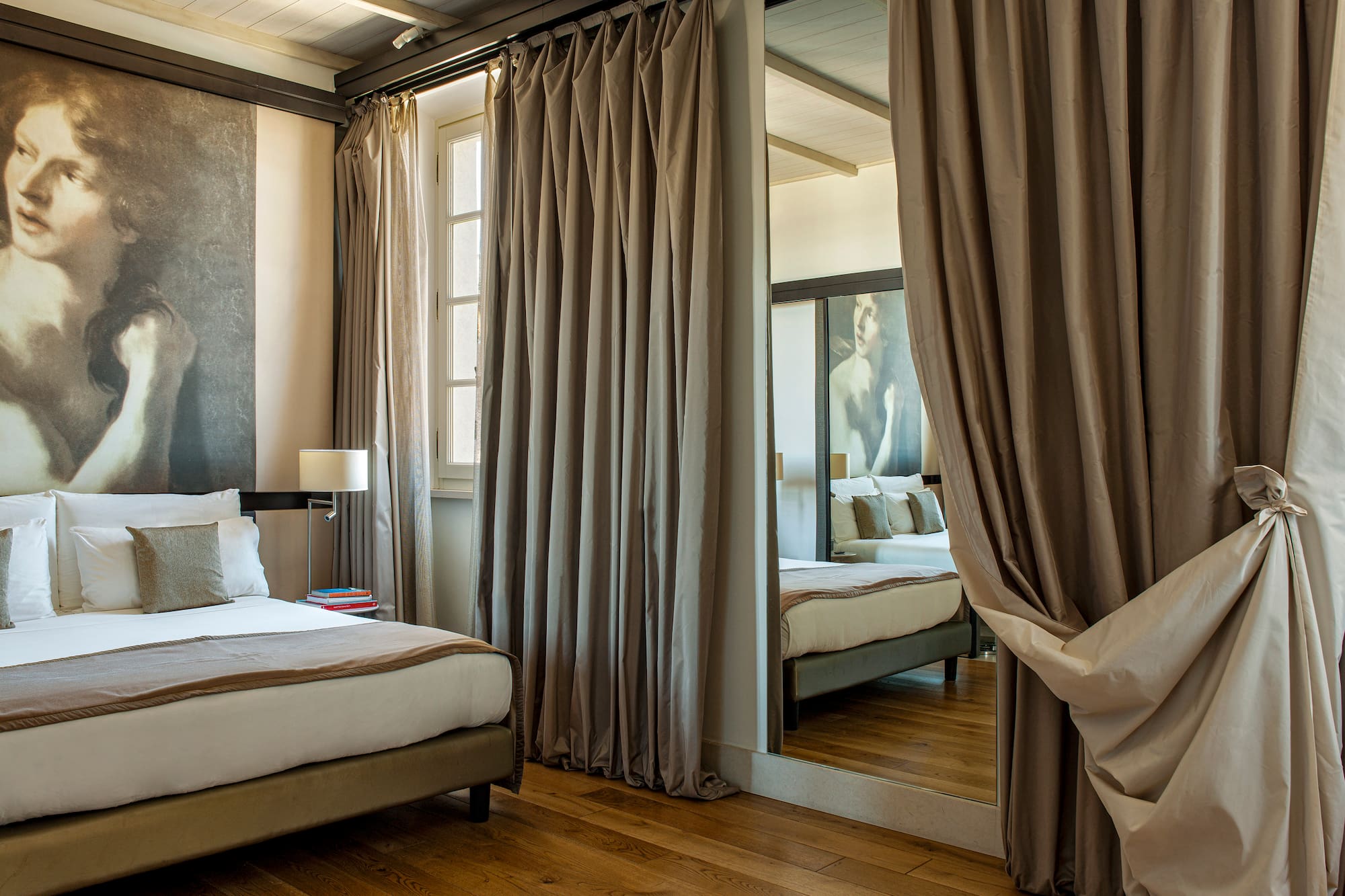 a room with a mirror and a bed