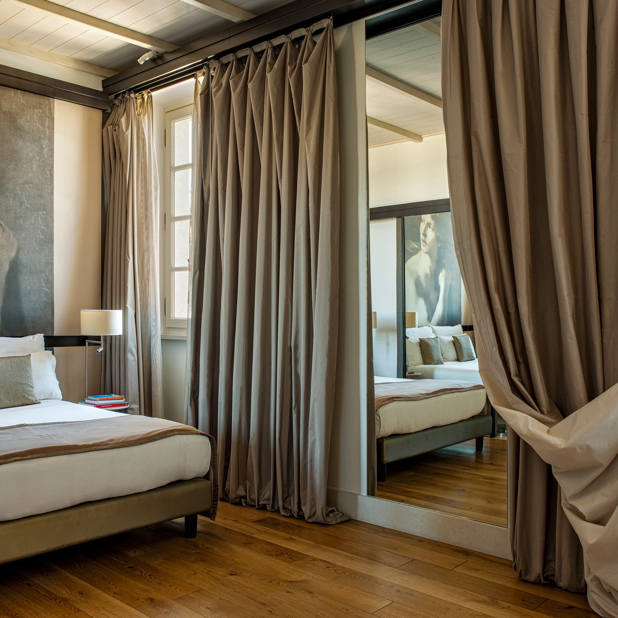 a room with a mirror and a bed