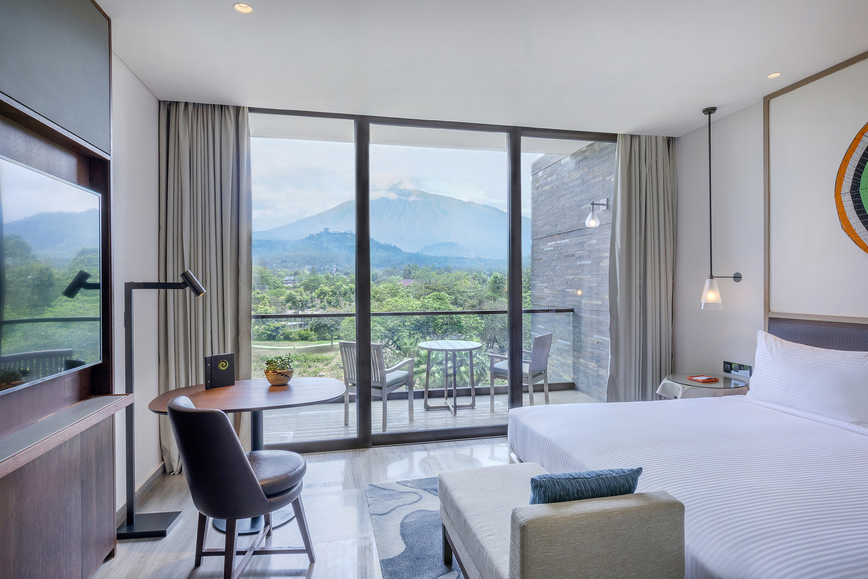a room with a bed and a table and chairs