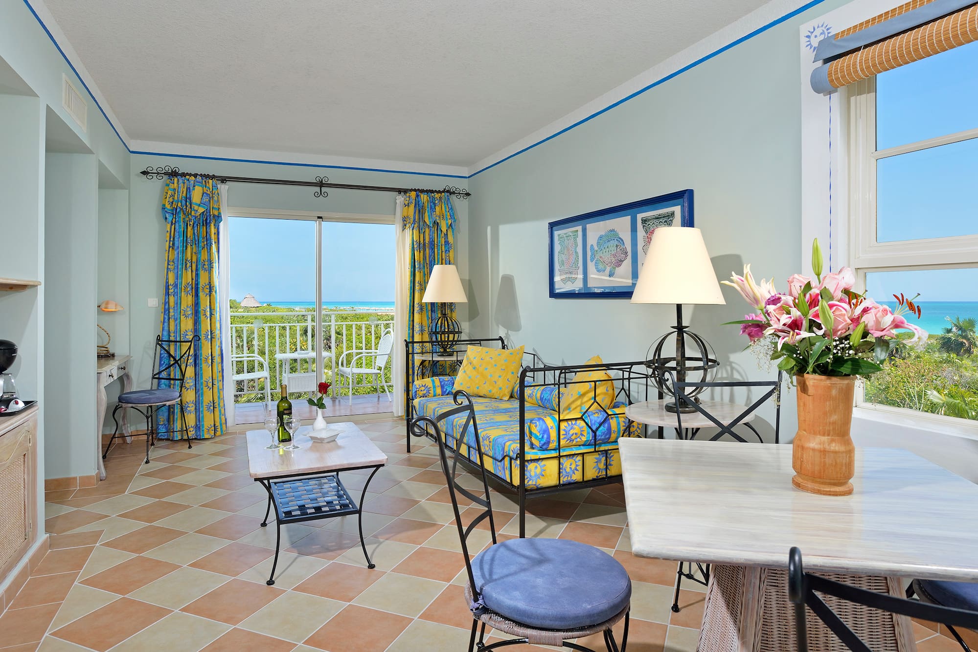 a room with a couch and table and chairs