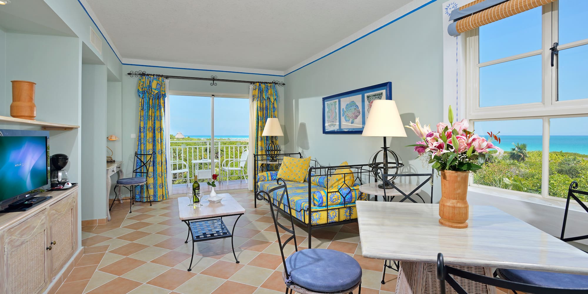 a room with a couch and table and chairs