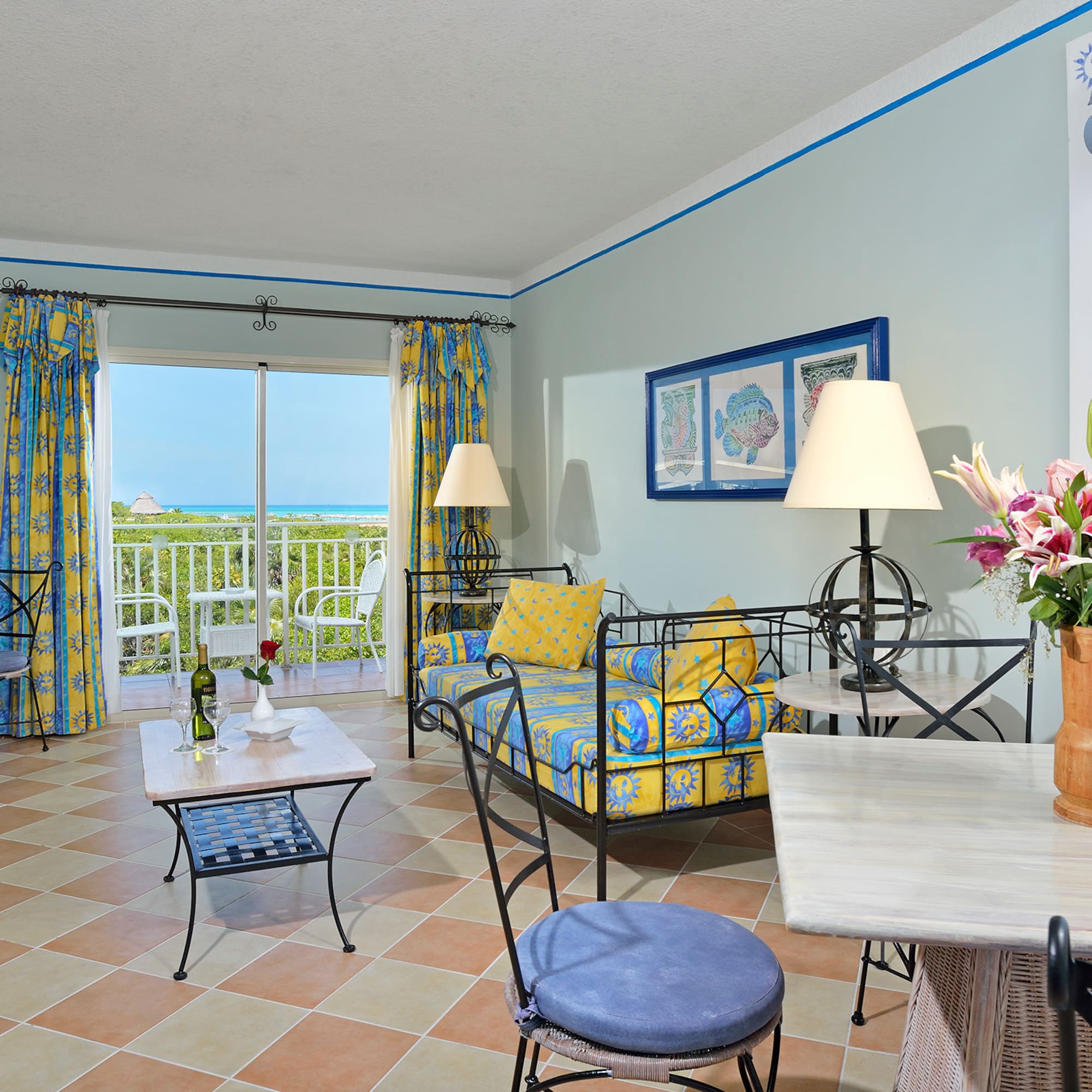 a room with a couch and table and chairs