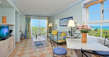 a room with a couch and table and chairs