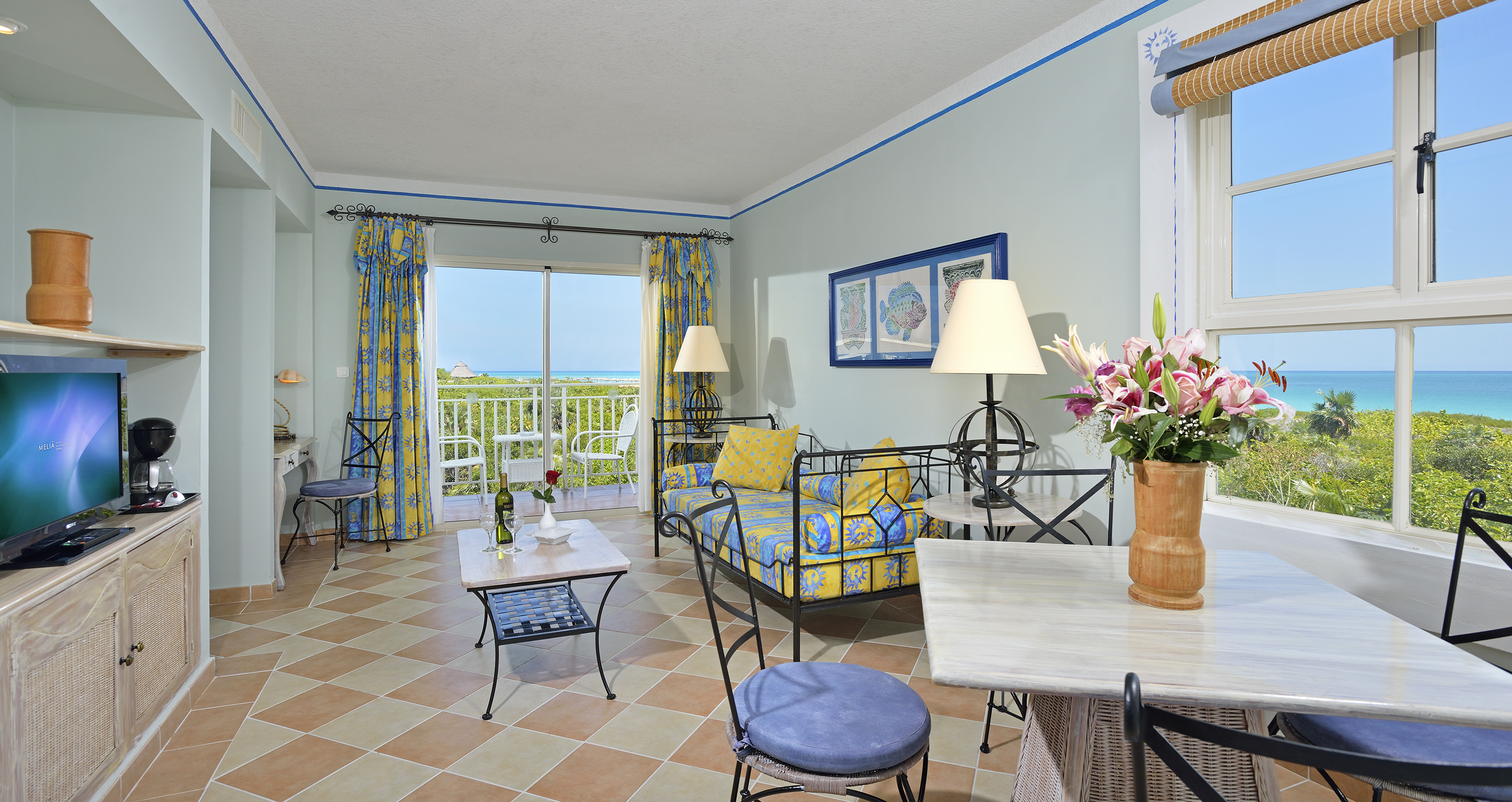 a room with a couch and table and chairs