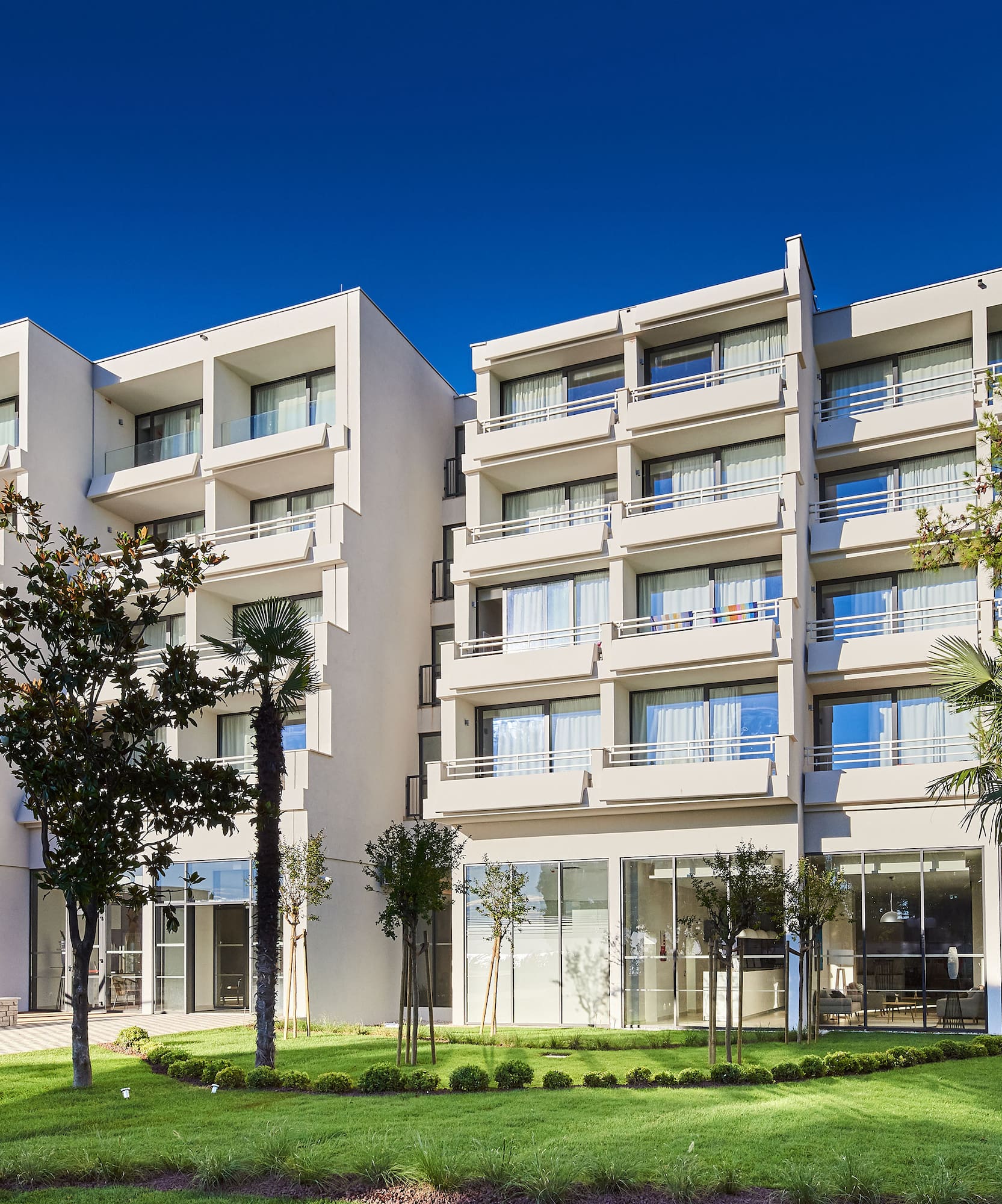 a building with trees and grass