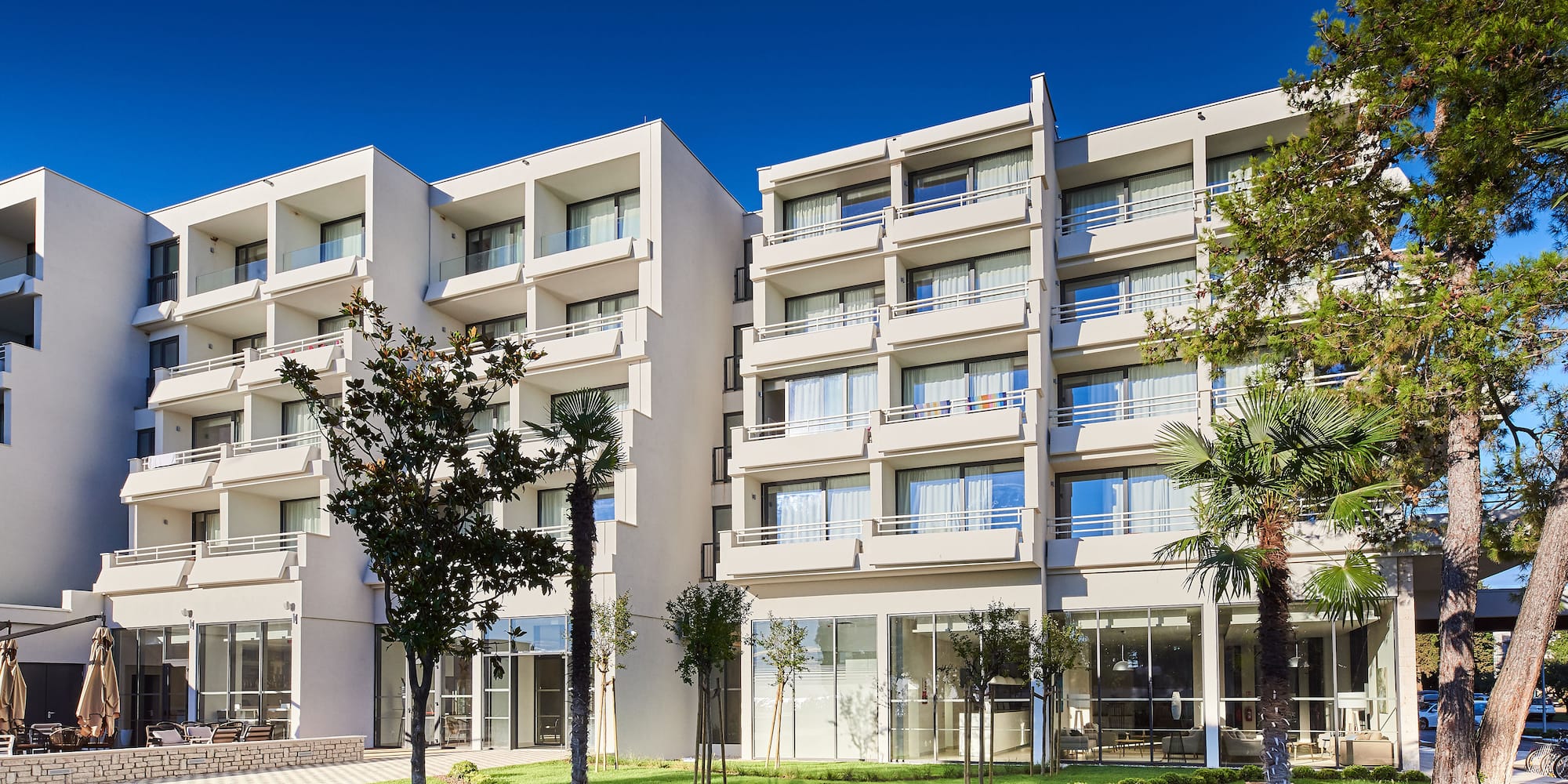 a building with trees and grass