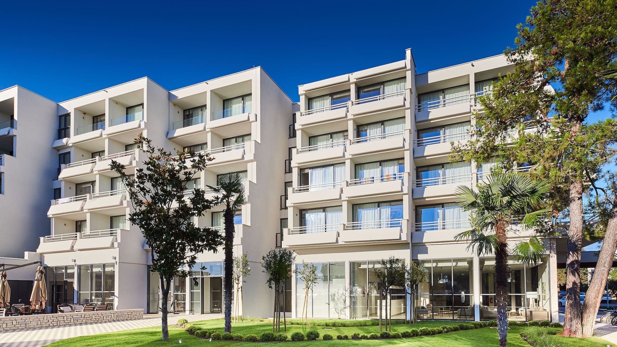 a building with trees and grass