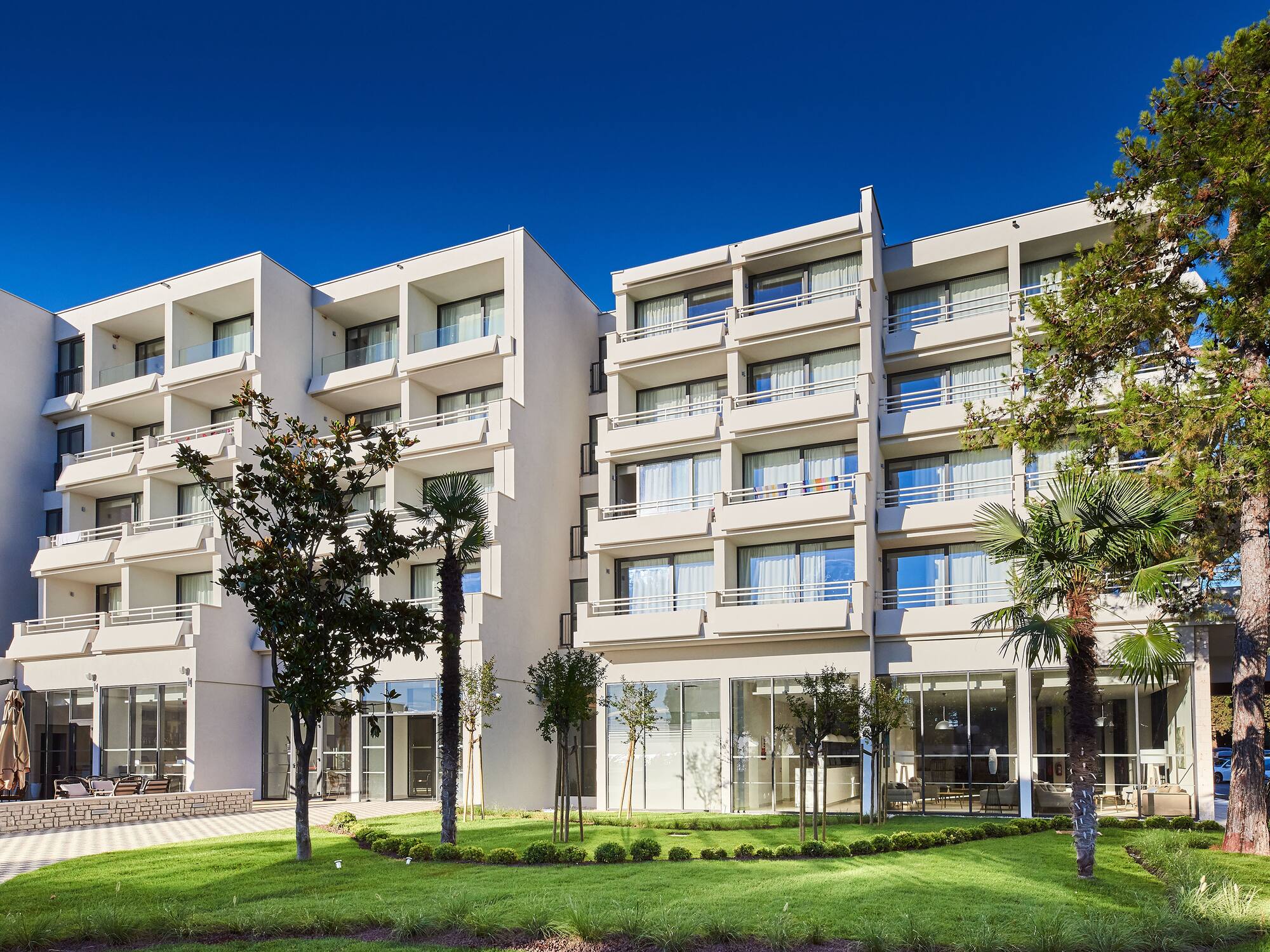 a building with trees and grass