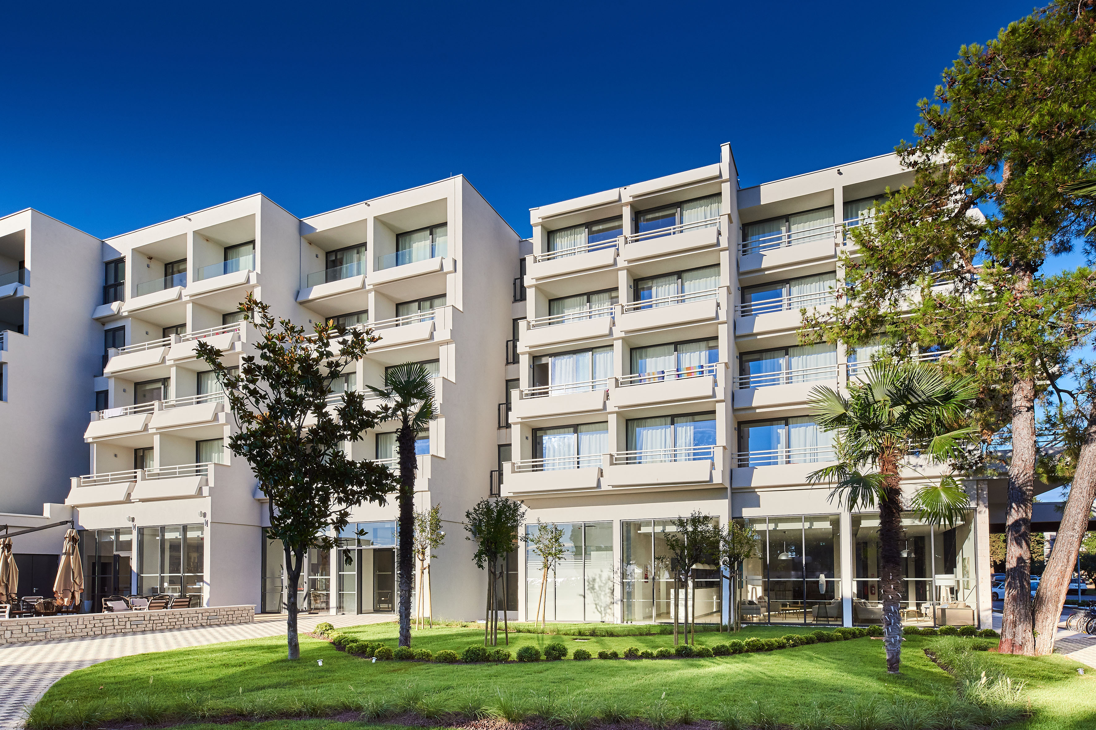 a building with trees and grass
