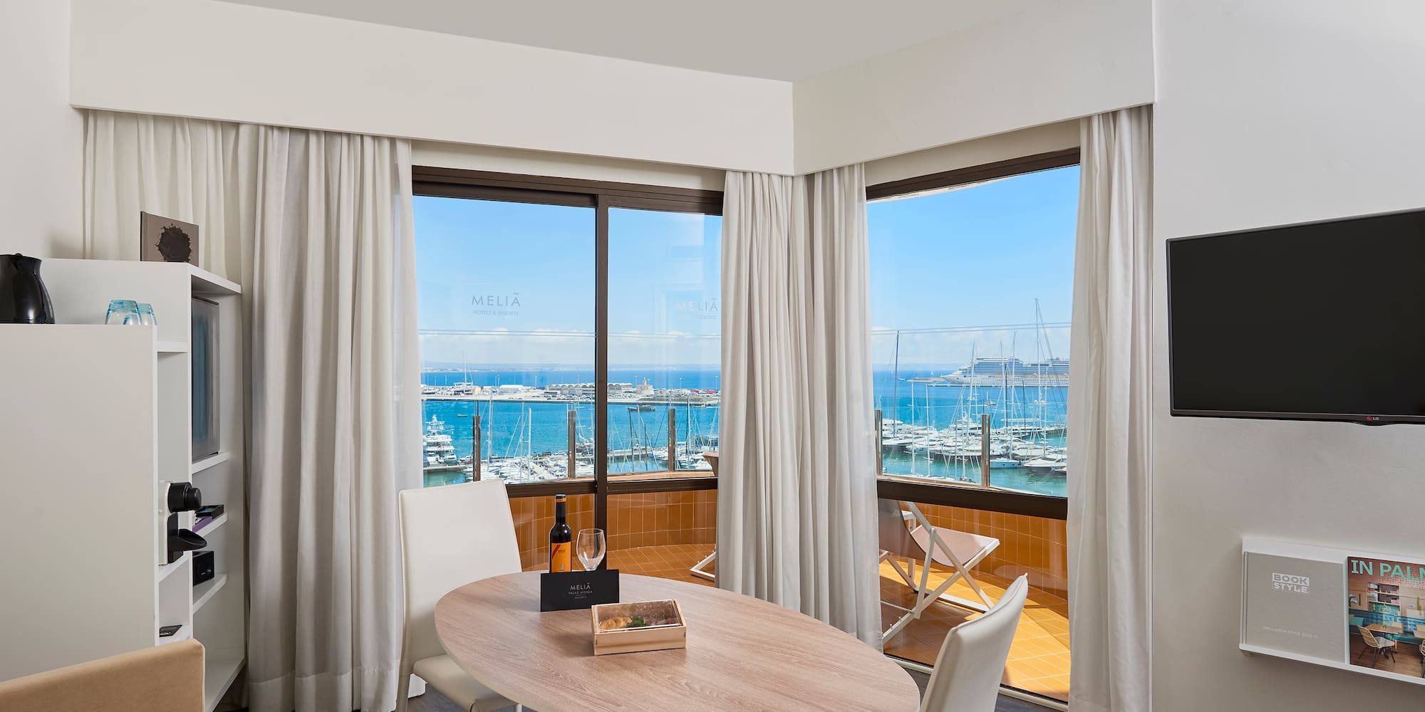 a room with a table and chairs and a television