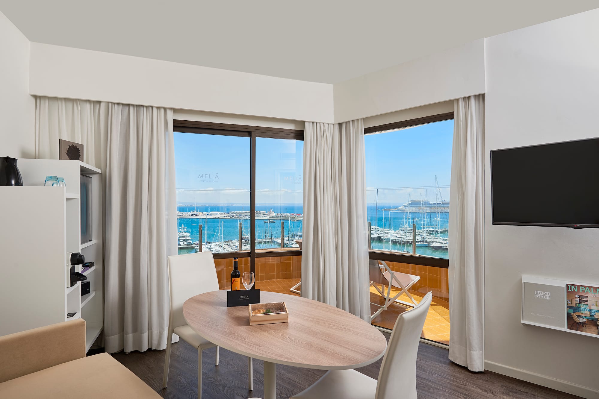 a room with a table and chairs and a television