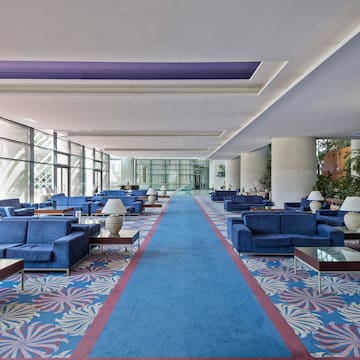 a blue couches and tables in a large room
