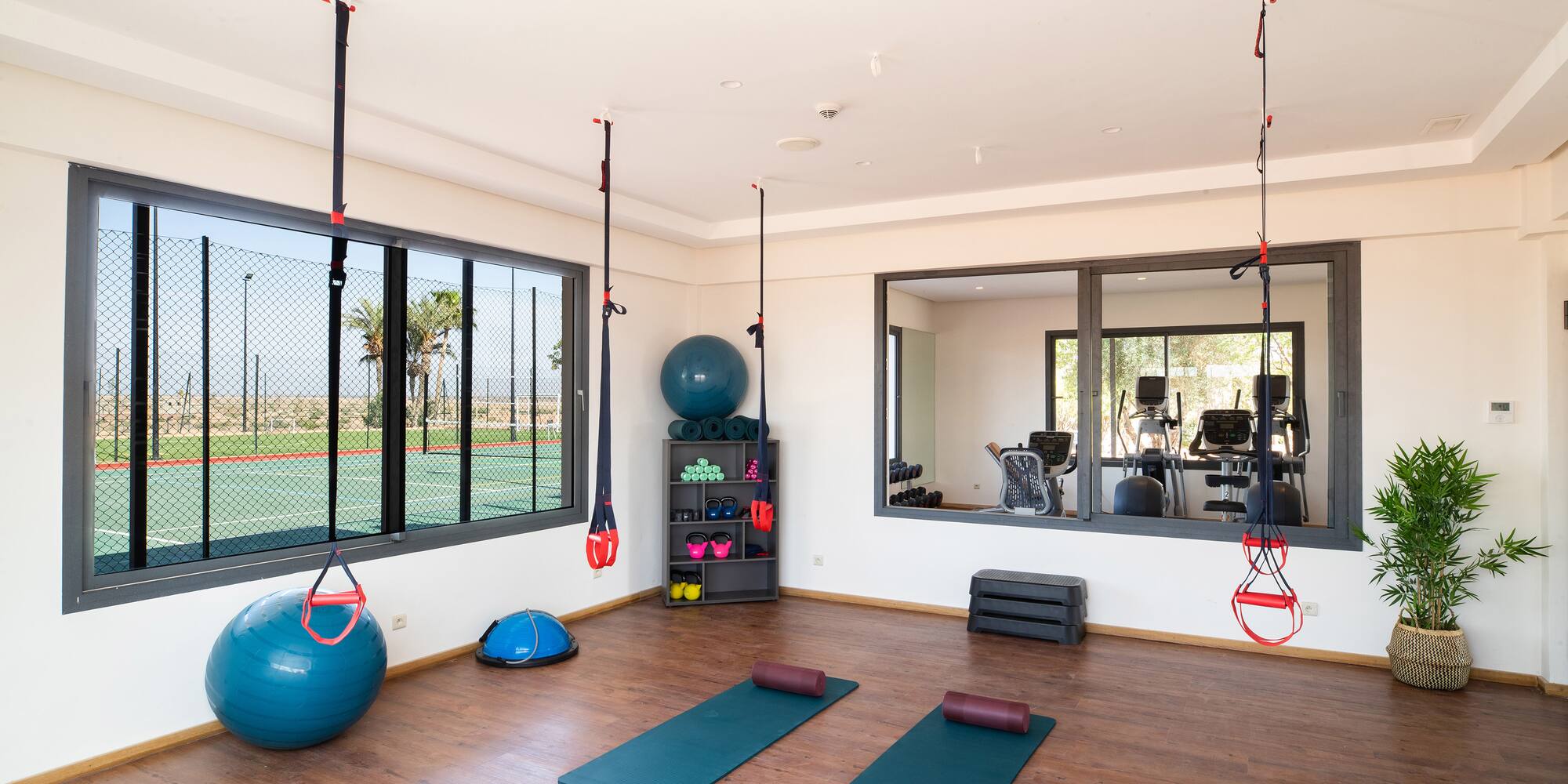 a room with yoga mats and balls
